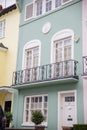 Light green British house with balconies and plants Royalty Free Stock Photo