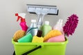 Light green bucket with cleaning products on beige background, closeup Royalty Free Stock Photo