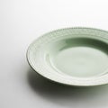 Light Green Ceramic Plate with Embossed Decorative Rim on White Background dishware tableware Royalty Free Stock Photo