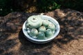 Light green ceramic tea set including jar, cups and plate on stone table under tree shadow at Ham Rong Mountain Park in Sa Pa Royalty Free Stock Photo