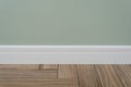 Light green matte wall, white baseboard