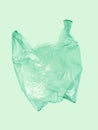 Light green plastic bag on green background. Royalty Free Stock Photo