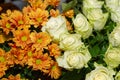 Light green rose and orange chrysanthemum. Bouquet of rosaprima green tea roses and orange daisy flowers close-up Royalty Free Stock Photo