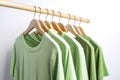 Light green shirts on hangers. Generate ai