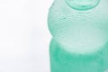 Light Green Sweated Frosty Bottle with Clear Pure Cool Water on White Background. Hydration Summer Refreshment