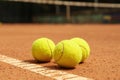 Light green tennis balls on clay court Royalty Free Stock Photo