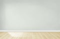 Light green wall in an empty room with a wooden floor Royalty Free Stock Photo