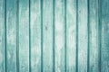 Light green wooden fence in lines. Wooden painted boards with scuffs. Old wood texture background. Copy space. Dilapidated wood su Royalty Free Stock Photo