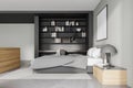 Light grey bedroom interior with bed, coffee table and bookshelf, mockup poster Royalty Free Stock Photo