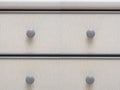 Light grey colored wooden cabinet drawers