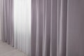 Light grey window curtains and white tulle indoors