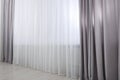 Light grey window curtains and white tulle indoors