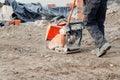 Light ground compactor used by groundworker on construction site Royalty Free Stock Photo