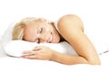 Light hair female model, smiling and lying on the pillow
