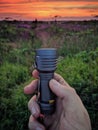 The light of a hand flashlight turns into sunset