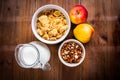 Light healthy breakfast: cornflakes, milk, apples and nuts Royalty Free Stock Photo