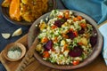 Light healthy dietary vegan dish: couscous with fresh and baked vegetables