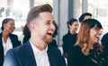 Light hearted moments keep everyone's attention. Shot of a group of businesspeople laughing while attending a