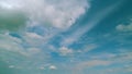 Light High Clouds Slide On Sky. Puffy Fluffy White Clouds Sky. Blue Sky With Clouds Moving In Opposite Direction And Sun Royalty Free Stock Photo