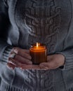 Light and hold a soy candle in your hands. Candle in a jar. Aromatheramia. Aroma candle. Royalty Free Stock Photo