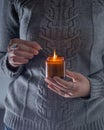 Light and hold a soy candle in your hands. Candle in a jar. Aromatheramia. Aroma candle. Royalty Free Stock Photo