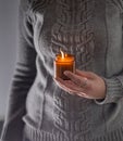 Light and hold a soy candle in your hands. Candle in a jar. Aromatheramia. Aroma candle. Royalty Free Stock Photo