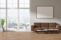 Light home living room interior couch and coffee table, window and mockup frame Royalty Free Stock Photo