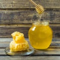 Light honey in the jar with spoon and honeycomb Royalty Free Stock Photo