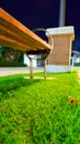 The light illuminates an orange bench located beside the walkway. Royalty Free Stock Photo