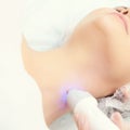 Light infrared therapy. Cosmetology head procedure. Beauty woman face. Cosmetic salon device. Facial skin rejuvenation