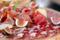 Light Italian snacks. A buffet table at a dinner party. Food tray with delicious salami, pieces of sliced ham, sausage Royalty Free Stock Photo