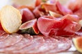 Light Italian snacks. A buffet table at a dinner party. Food tray with delicious salami, pieces of sliced ham, sausage Royalty Free Stock Photo