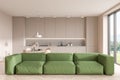 Light kitchen interior with couch and cooking area, panoramic window Royalty Free Stock Photo