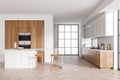 Light kitchen interior with island and seats, appliances and panoramic window Royalty Free Stock Photo