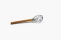 Light kitchen tools, stainless whisk with a wooden handle for egg beater, milk blender for blending, whisking, stirring on white b