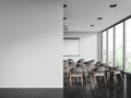 Light learning interior with chairs in row, projection screen and mock up wall