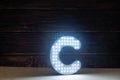 The light letter C is part of an advertising sign.