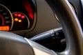 Light lever and steering wheels of modern car dashboard with blurry and soft focus instrument background