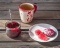 Light lunch with sweets, tea in a large ceramic mug and a glass jar with cherry jam and a teaspoon rustic style, on a Royalty Free Stock Photo