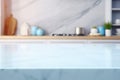 Light marble table with blurred modern blue colored kitchen set, photorealistic blurred bokeh background with copyspace Royalty Free Stock Photo