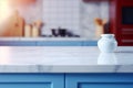 Light marble table with blurred modern blue colored kitchen set, photorealistic blurred bokeh background with copyspace Royalty Free Stock Photo