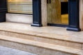 Light marble threshold with steps at the entrance to the glass door. Royalty Free Stock Photo