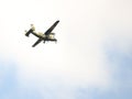 A light military landing turboprop aircraft of the Polish Armed Forces flies across the sky with landing gears released