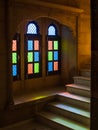 Light from multicoloured stained glass window panes
