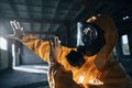 Light from nuclear explosion. Man dressed in chemical protection suit in the ruins of the post apocalyptic building Royalty Free Stock Photo