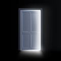 Light from the open door of a dark room, a mystical glowing exit. Royalty Free Stock Photo