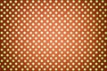 Light orange background from wrapping paper with a pattern of golden polka dot closeup Royalty Free Stock Photo