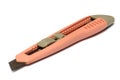 A light orange pink plastic penknife with a rusty blade white backdrop