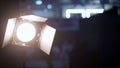 The light is out of focus. Beautiful background with light in the foreground. theater spot lights on black curtain with smoke. Royalty Free Stock Photo