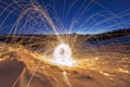 Light painting art. Spinning steel wool in abstract circle, firework showers of bright yellow glowing sparkles on winter snowy